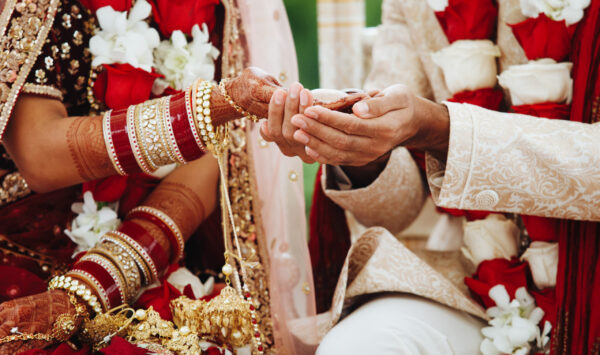 hands-indian-bride-groom-intertwined-together-making-authentic-wedding-ritual-scaled.jpg